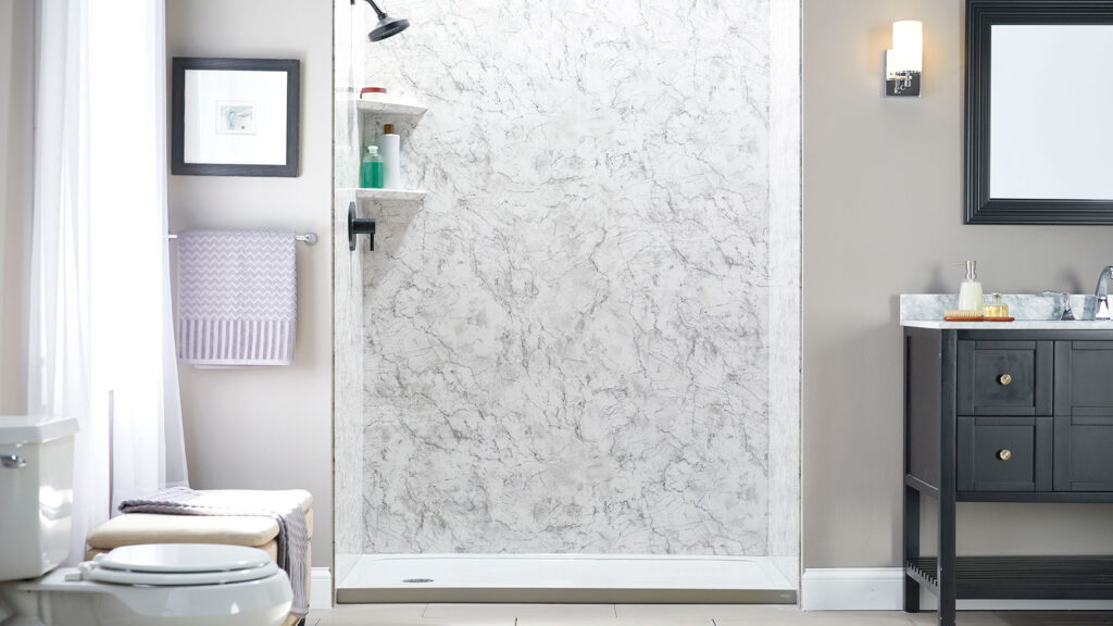 Elegant bathroom featuring Jacuzzi Midnight Storm acrylic wall system with deep marble patterns, paired with matte black fixtures.